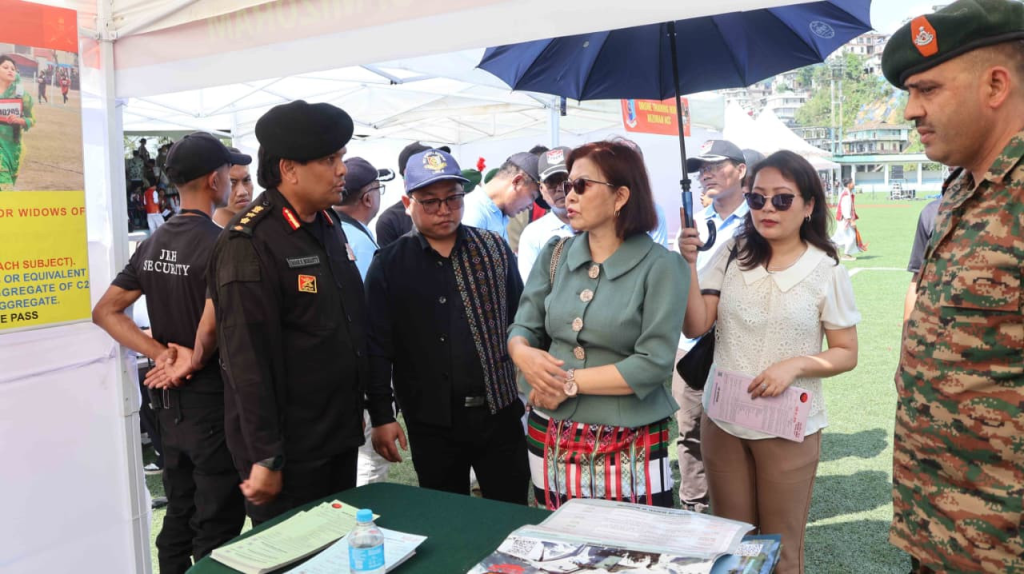 Minister Pi Lalrinpuii interacting with senior police and civil officers at an exhibition stall.