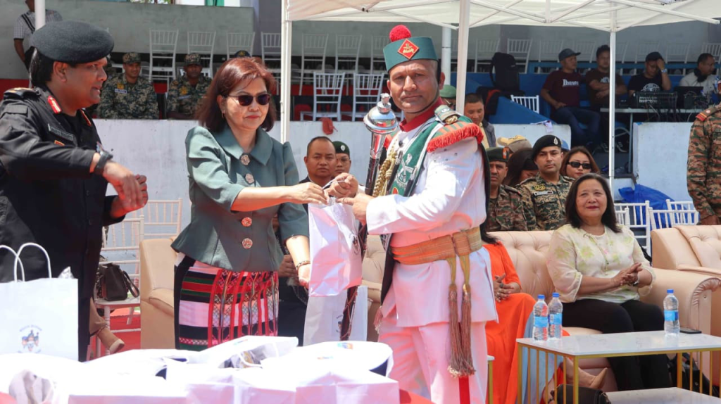 Minister Pi Lalrinpuii presenting a memento or shawl to a senior NCC or military officer in ceremonial uniform.