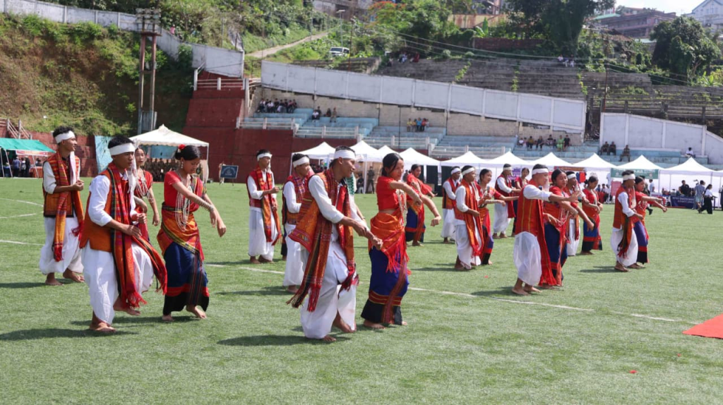 Male performers in traditional Mizo warrior attire dancing during the NCC Fest cultural programme.
